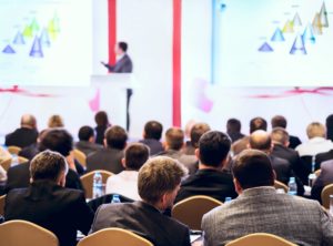 Speaker in front of large audience