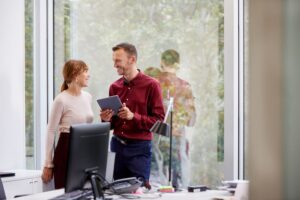Businessman Discussing With Colleague In Office