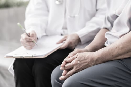 Doctor meeting with elderly patient