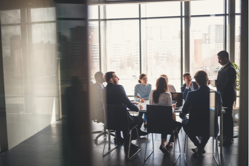 Business meeting taking place in conference room.
