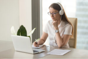 Photo of woman working on laptop in a home office.