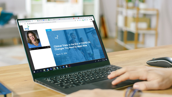 Photo of laptop with WCG COVID-19 webinar series.